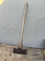 Full view of antique double-bit axe showing entire handle and head