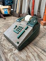 Three-quarter view showing overall adding machine and roll