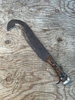 Full view of billhook axe showing blade curvature and handle