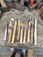 Top view of all 10 hickory hammer handles on table