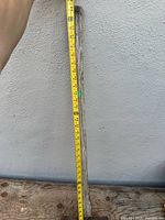 Full view of handle with tape measure indicating length