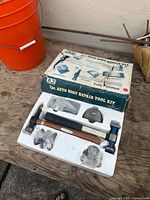 box marked AJ 7pc auto body repair tool kit with contents in foam tray