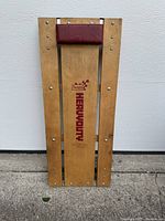 Front view showing logo, wood slats and headrest