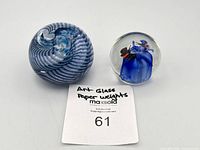 Top view of both paperweights displaying spiral and butterfly designs