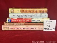 Stack of five cookbooks showing spines and titles