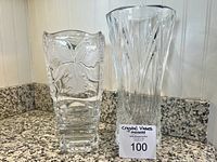 Both crystal vases side by side for scale and comparison