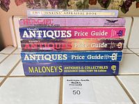 Stack of seven reference books showing titles on spines