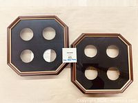 Front view of both octagonal frames with four circular openings each