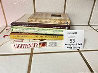 Stack of five books showing spines and bookmark tag