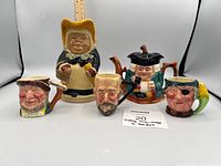 Front view of all five figural ceramic pieces