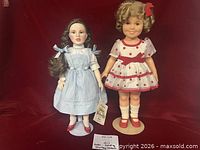 Full view of both dolls on stands
