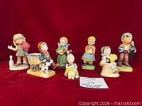 All six figurines arranged on red background