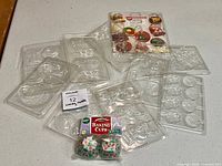 Group shot of all plastic candy molds and sealed baking cups