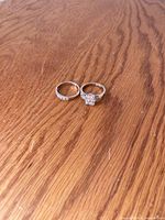 Both rings side by side on wooden surface