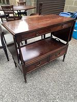 Front three-quarter view showing overall buffet table, drawers, tray and legs