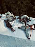 Group shot of four corded tools on table