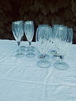 Twelve stemmed glasses on table