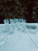 Group of Cornflower glassware on table: glasses, plates, creamer, sugar