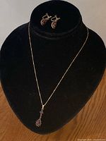 Full view necklace on bust with earrings displayed