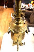 Full view of brass samovar front showing spigot, handles, square base