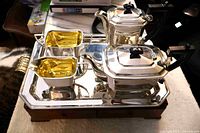 Full view of complete silver plate tea set on tray and stand