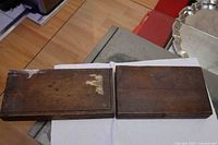 Two closed oak cases showing exterior wear