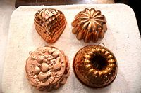 All four Jello molds arranged on cloth showing overall condition