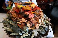 Stacked view of multiple autumn wreaths showing twig bases, mixed leaves and berries