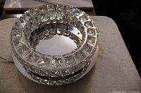 Angled view showing chrome base and concentric crystal rings