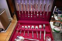 Open chest showing knives in lid and main tray with spoons, forks and serving pieces