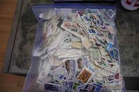 Full view of resealable bag packed with loose Canadian stamps