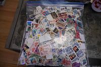 Full view of clear bag packed with assorted U.S. stamps