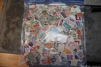 Full view of gallon zipper bag filled with loose worldwide stamps