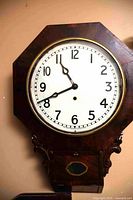 Front view of Arthur Pequegnat wall clock showing octagonal dial and lower case