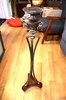 Full view of metal plant stand upright on floor