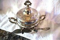 Closed butter dish with lid and knife attached