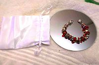 Bracelet and satin pouch on mirror