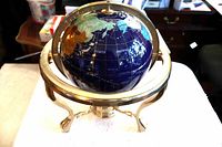 Full view of globe in gold-plated stand