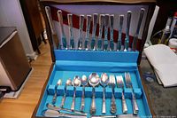 Open canteen showing full set of knives in lid and assorted forks, spoons, spreaders in tray