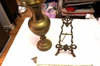 Overall view of brass vase, easel and snuffer