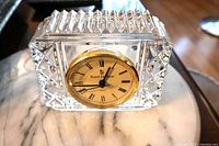 Front view of crystal clock showing dial and cut crystal design