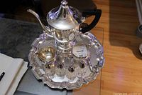 Full lot on tray showing teapot, creamer, sugar, shakers, pie lifter