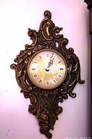 Full view of ornate brass wall clock