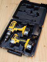 Open case showing both tools, batteries and charger