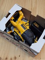 Boxed view showing DeWalt reciprocating saw, charger and batteries