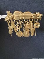 Front view showing violin bar and dangling instrument charms