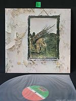 Front cover of Led Zeppelin IV LP with record partially visible