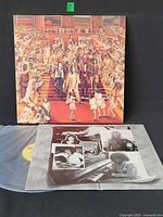 Front cover artwork and inner photo sleeve with vinyl partially visible