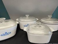 All four CorningWare dishes with lids displayed