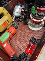 Overall view of Craftsman router, B&D drill and jig saw in basket